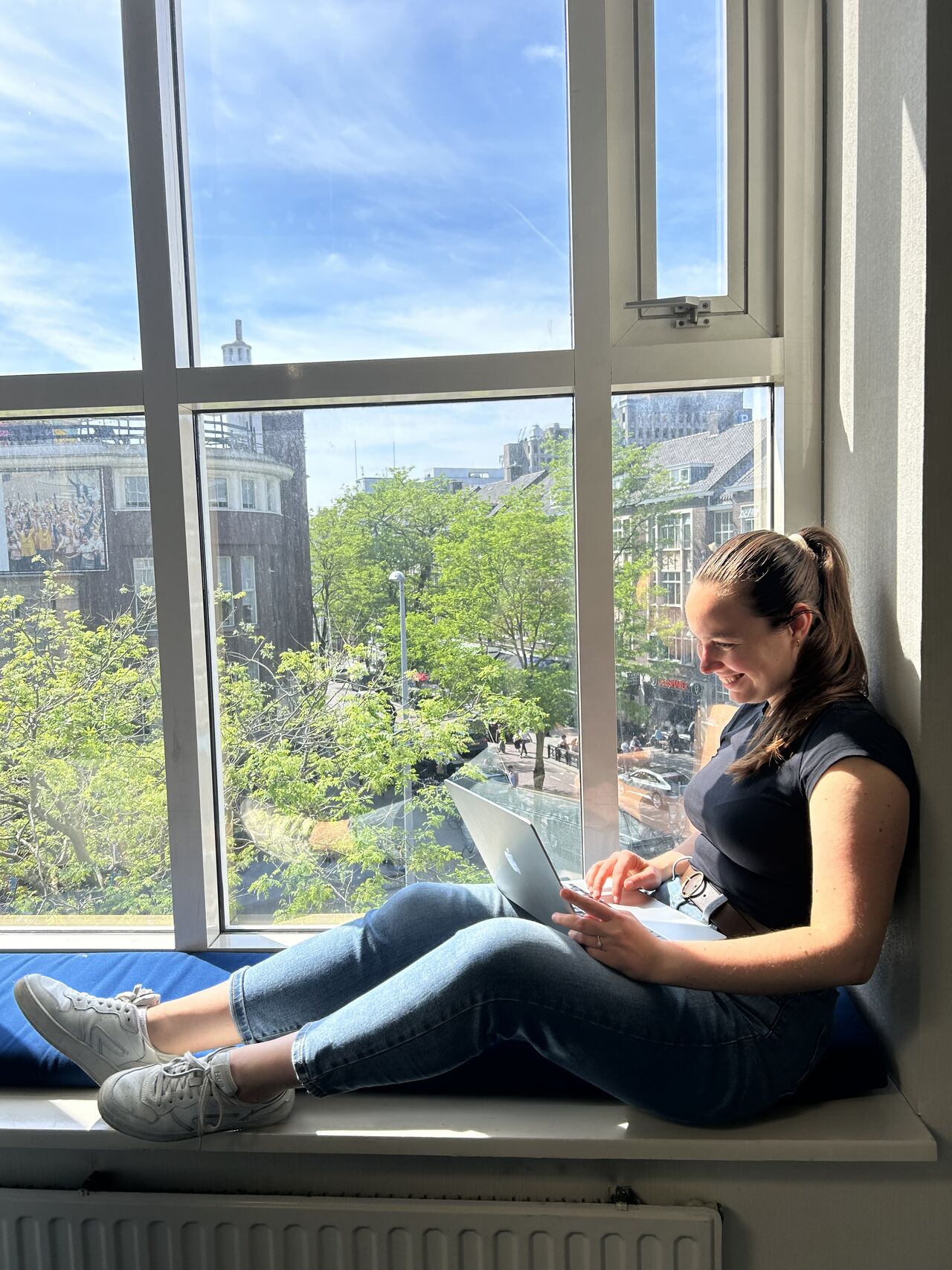 Vera working from a sunny window sill